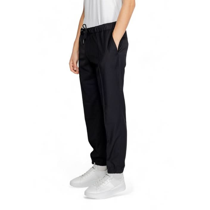 Men's plain black Armani Exchange trousers with a sophisticated design, ideal for both formal and casual settings, made from premium materials.